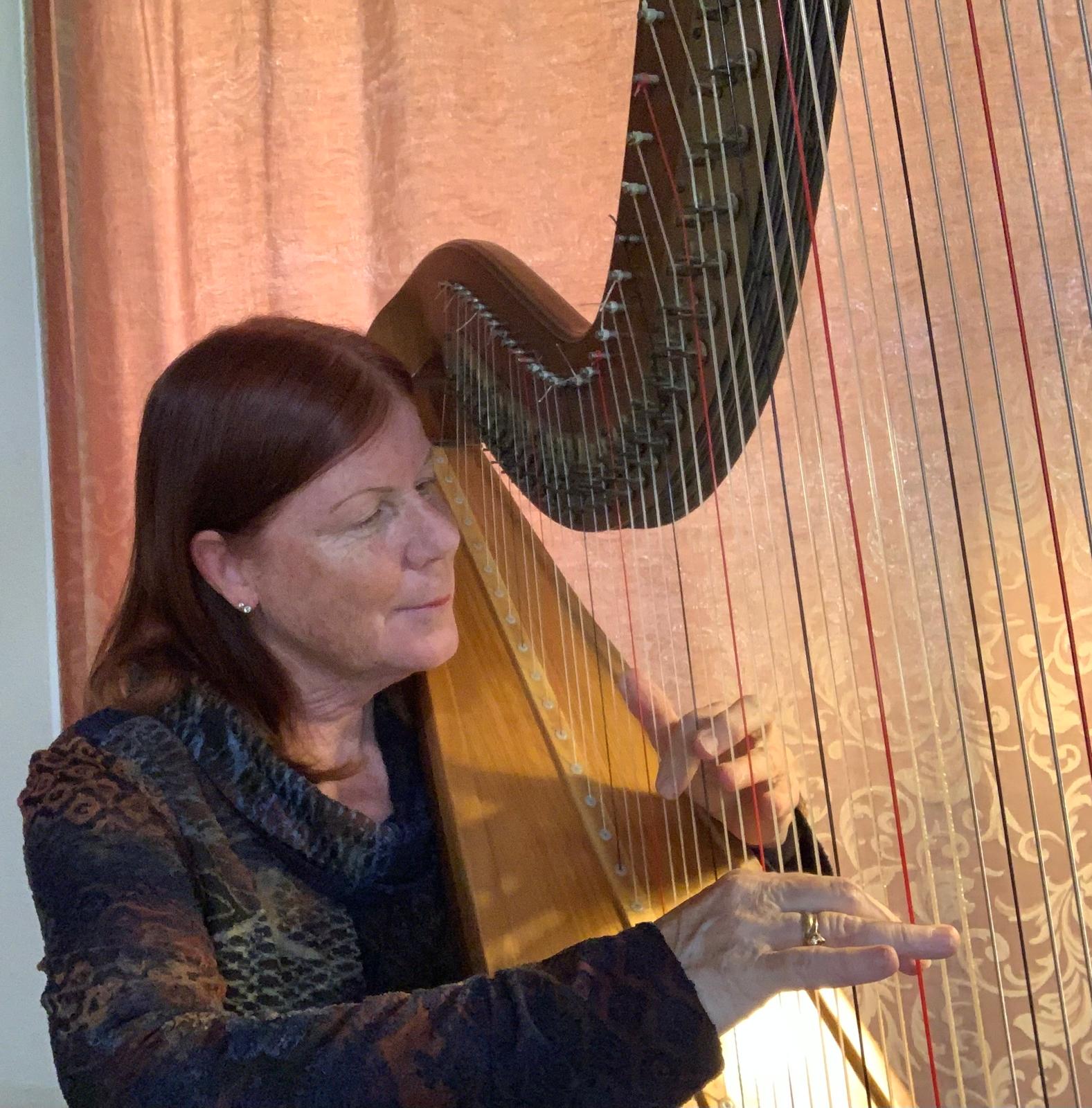 Renee playing her concert harp